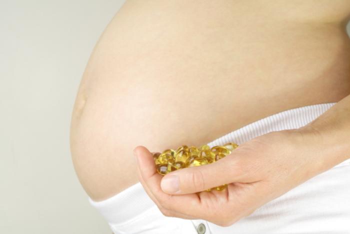 Pregnant woman taking pills