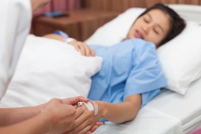 Pregnant woman receiving pain relief.