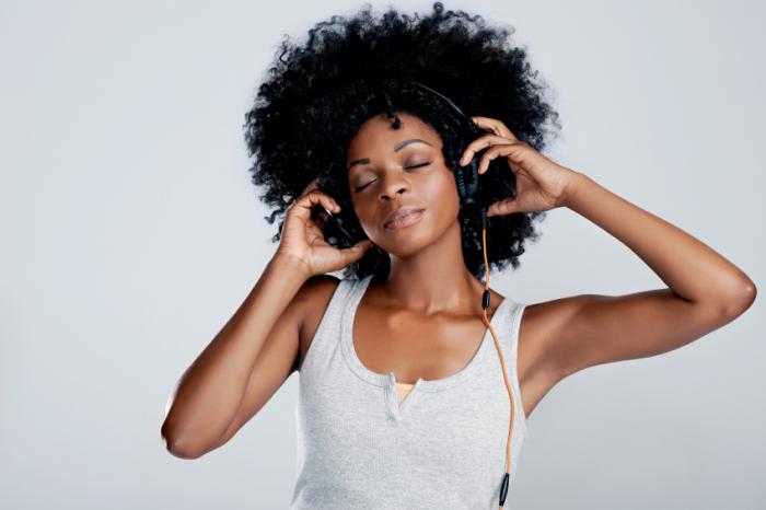 A woman enjoys listening to some music.