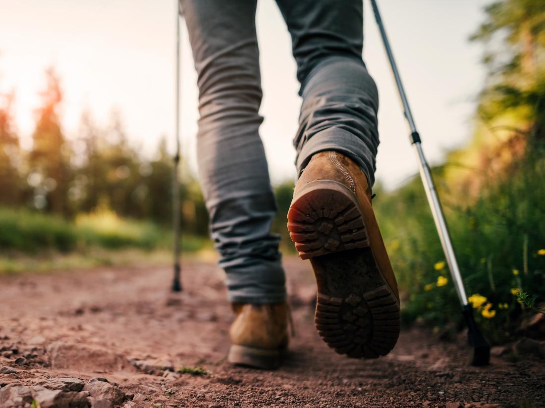 a view of a persons legs who is on a hike or walk.