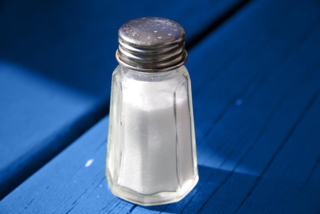 Salt shaker on blue wooden table