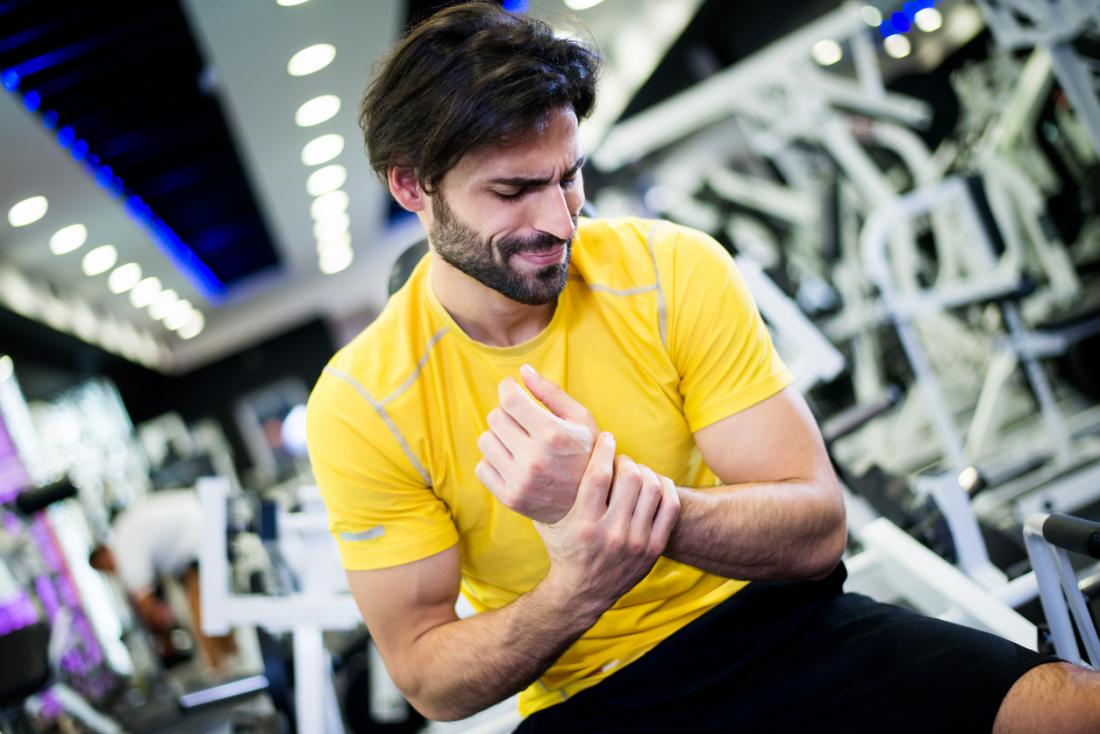 Man holding his injured wrist after exercise.