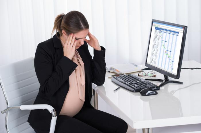 A depressed pregnant woman has a headache at work.