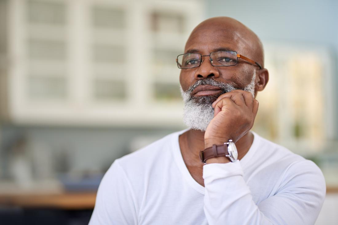 a man looking pensive as he contemplates his liver cancer diagnosis