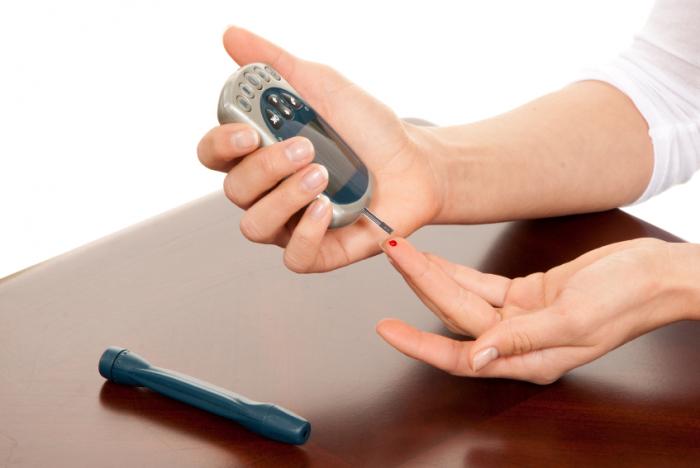 A woman taking a blood sugar reading