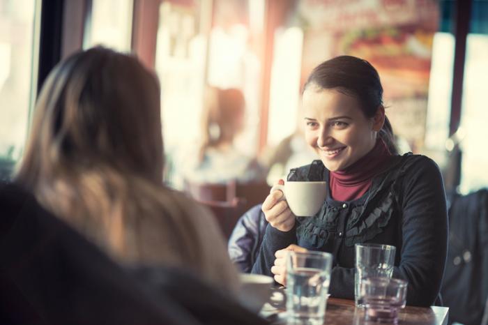 Two friends share a coffee