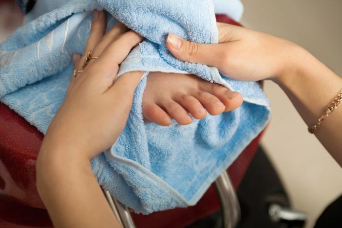 Drying a foot with a towel