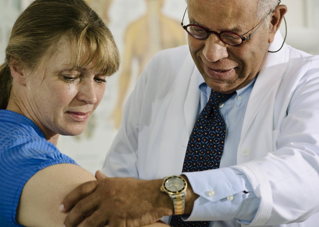 Doctor examines arm