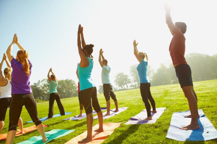 People doing yoga in the park