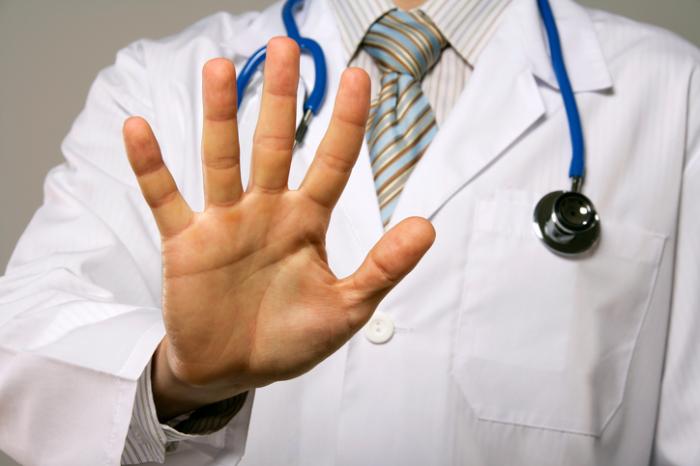 Doctor holds up right hand
