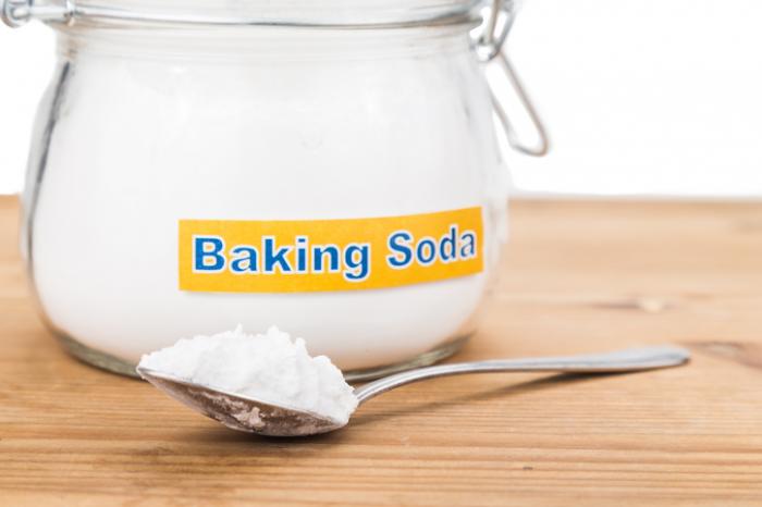 a jar and spoon of baking soda