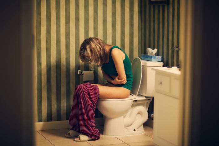 Lady with bladder infection on the toilet