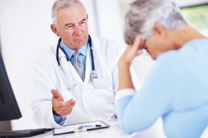 Lady receiving bad news from her doctor