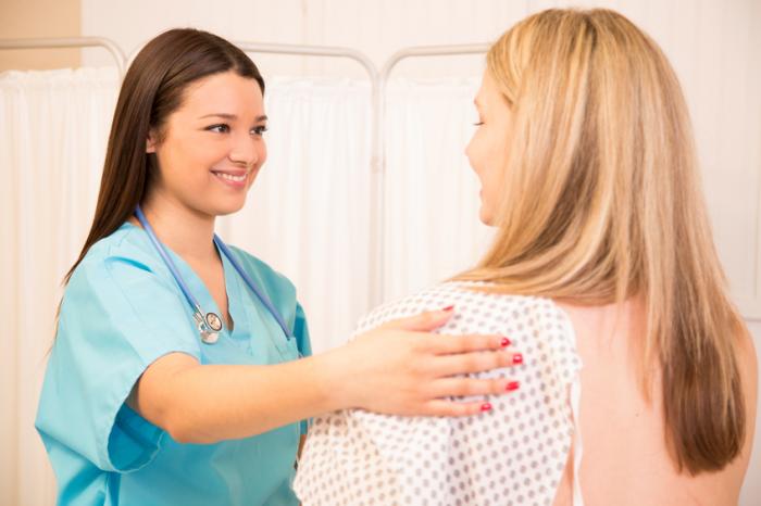 friendly female doctor reassures female breast cancer patient