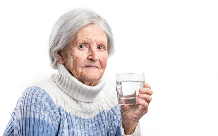 older lady with glass of water