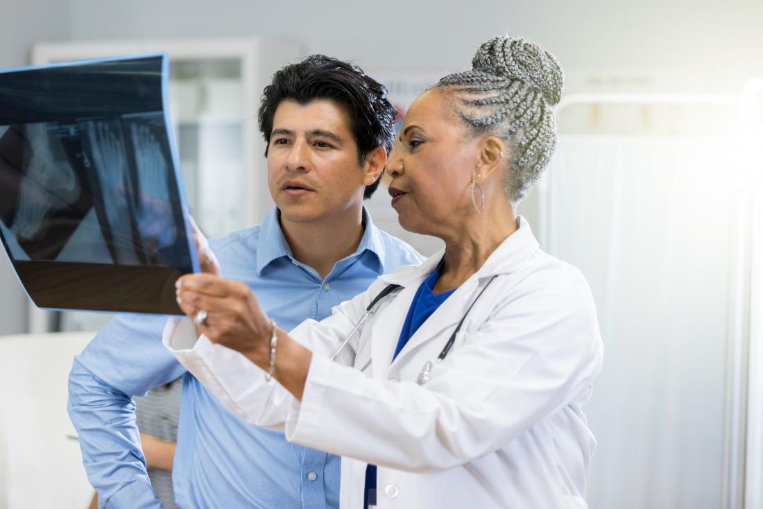 doctor and patient looking at x ray of psoriatic arthritis