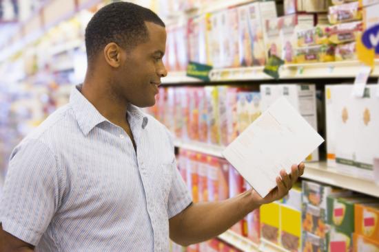 man reading nutrition information in a suprmarket