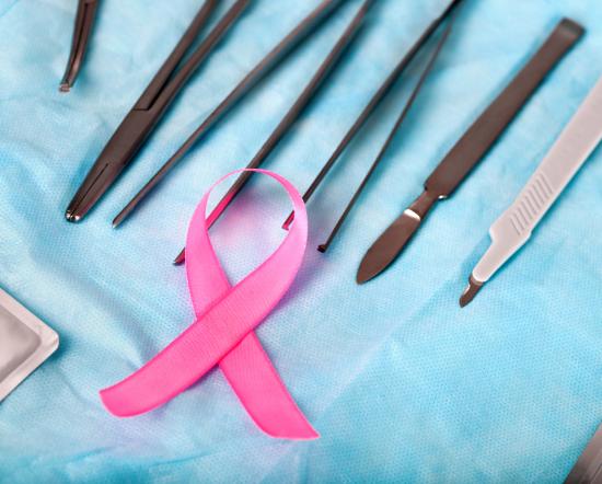 [pink breast cancer ribbon with surgical instruments]