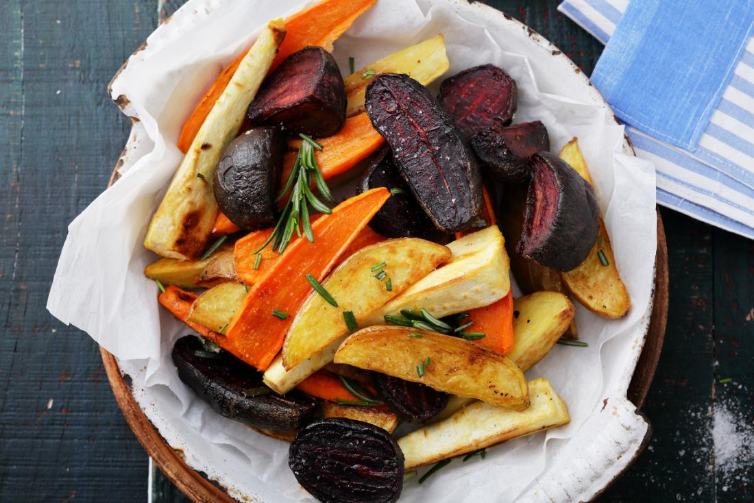 roasted vegetables including potato carrots beetroot and parsnips in a bowl