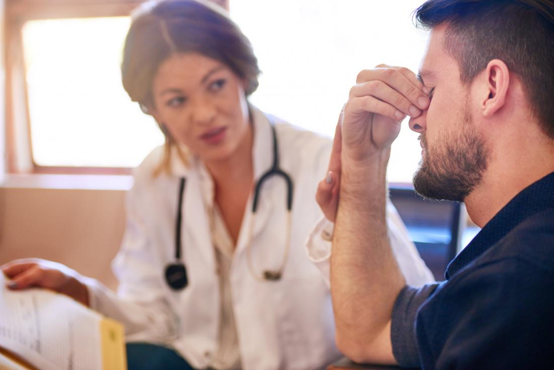 man with headache at the doctors