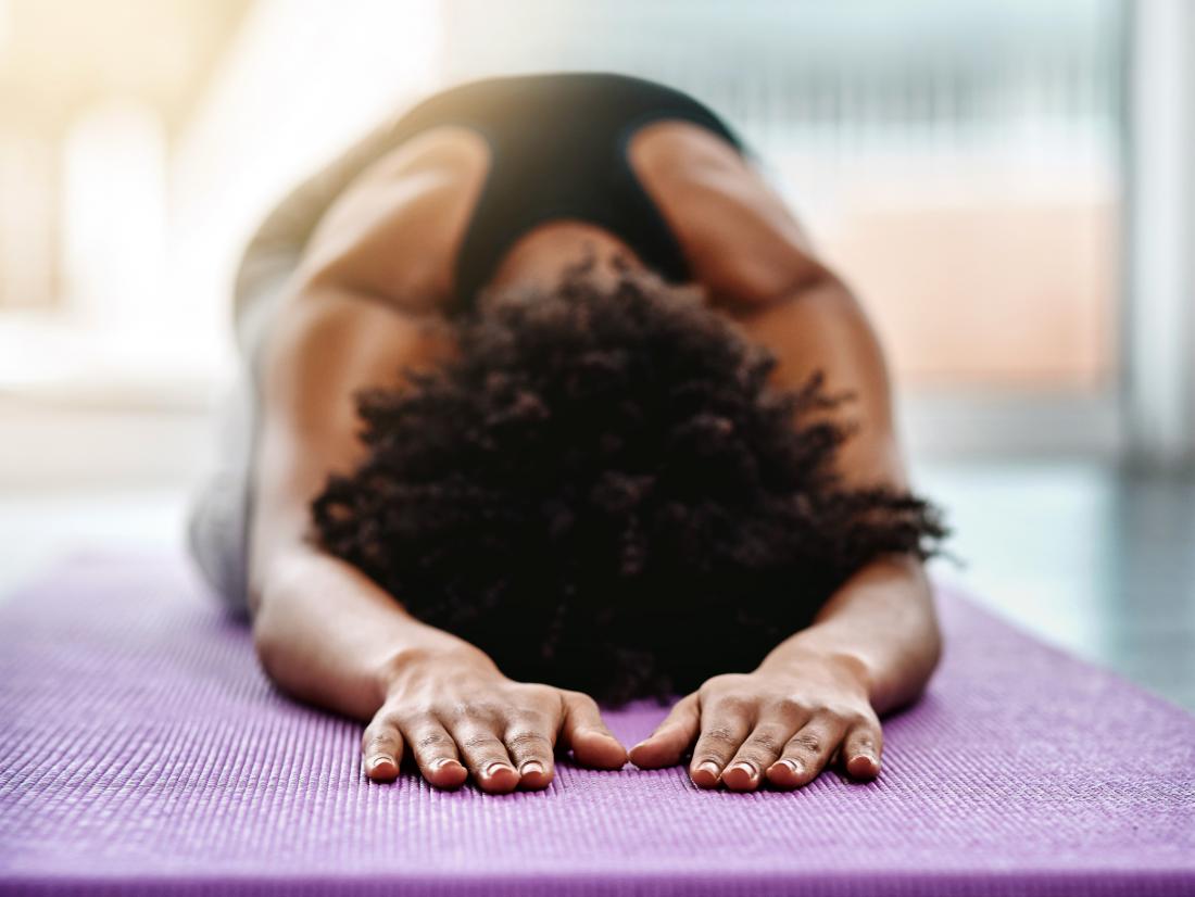 a woman doing childs pose during a yoga session