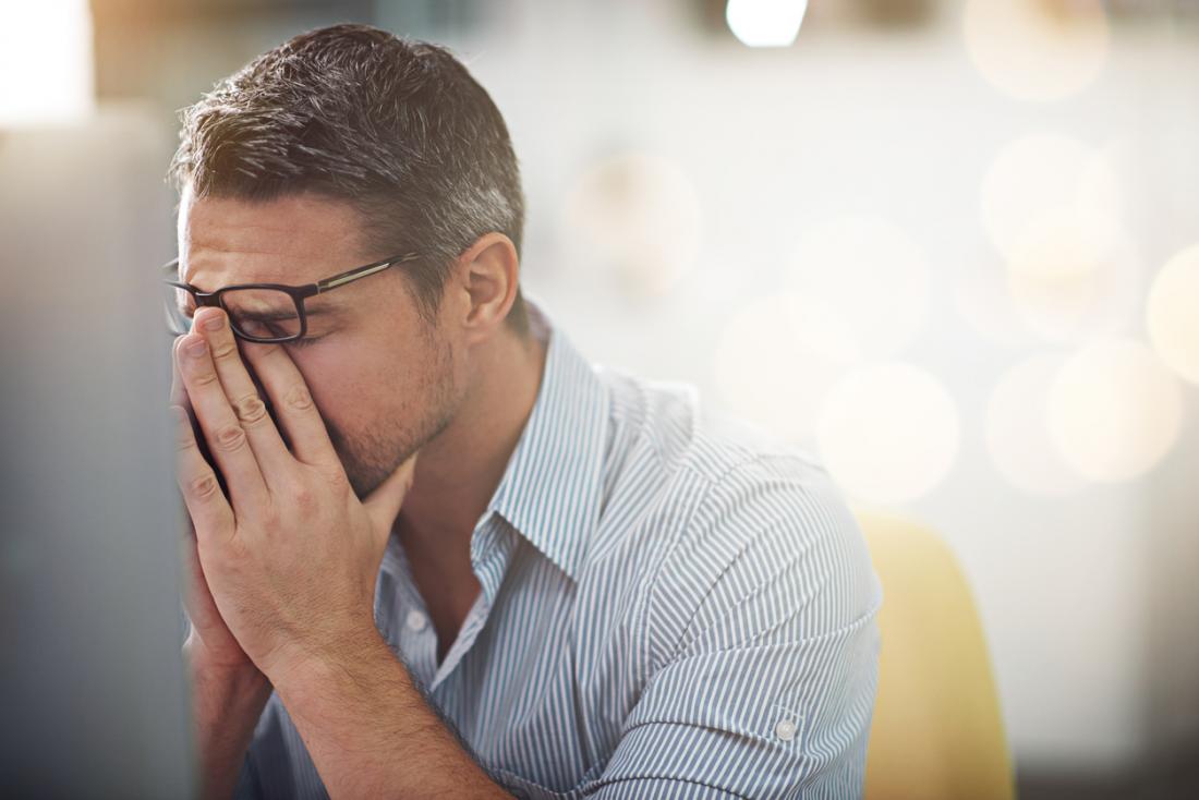 Man holds his face in his hands