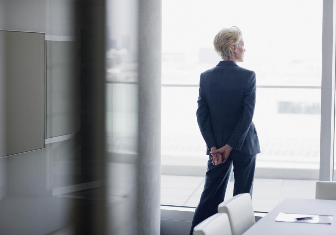 older business woman looks out of the window