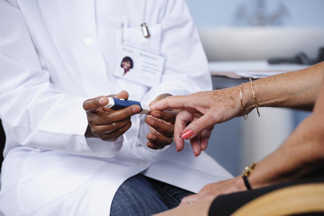 health care professional checking a patients blood sugar