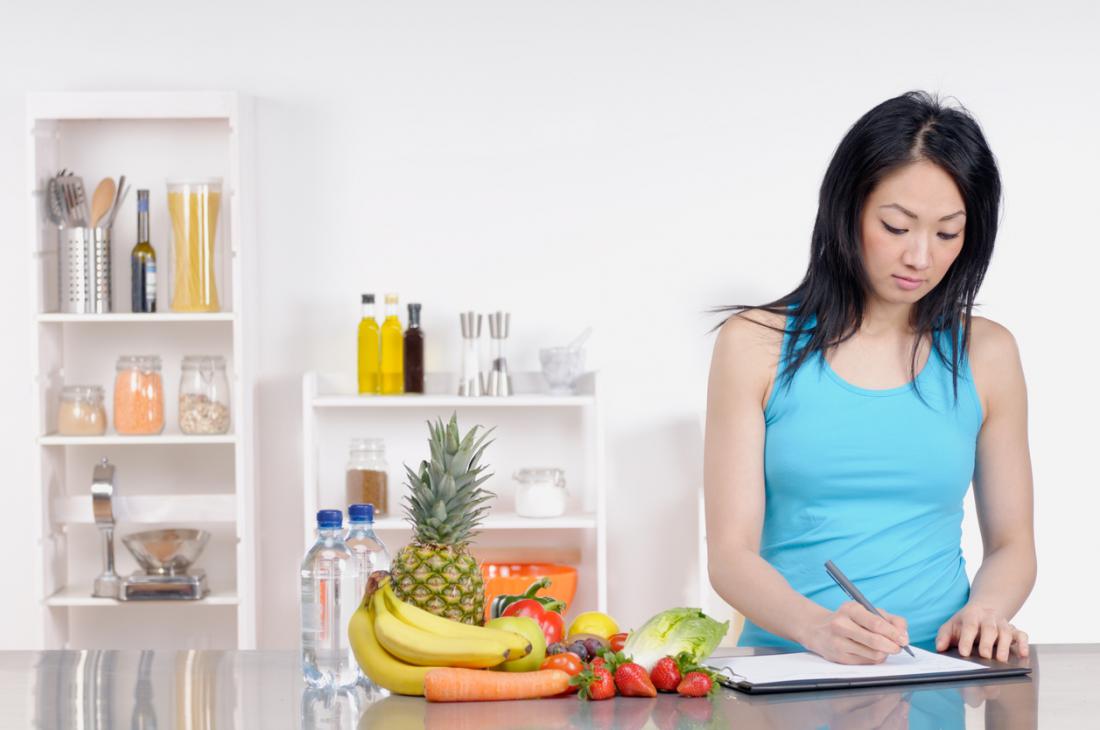 woman writing nutrition plan
