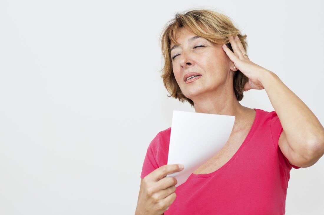 lady fanning herself with paper