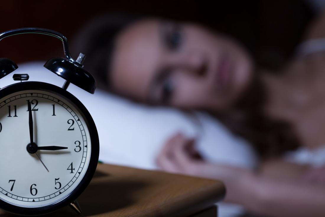 lady with insomnia staring at the back of her clock