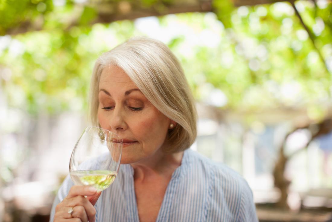 older lady drinking white wine