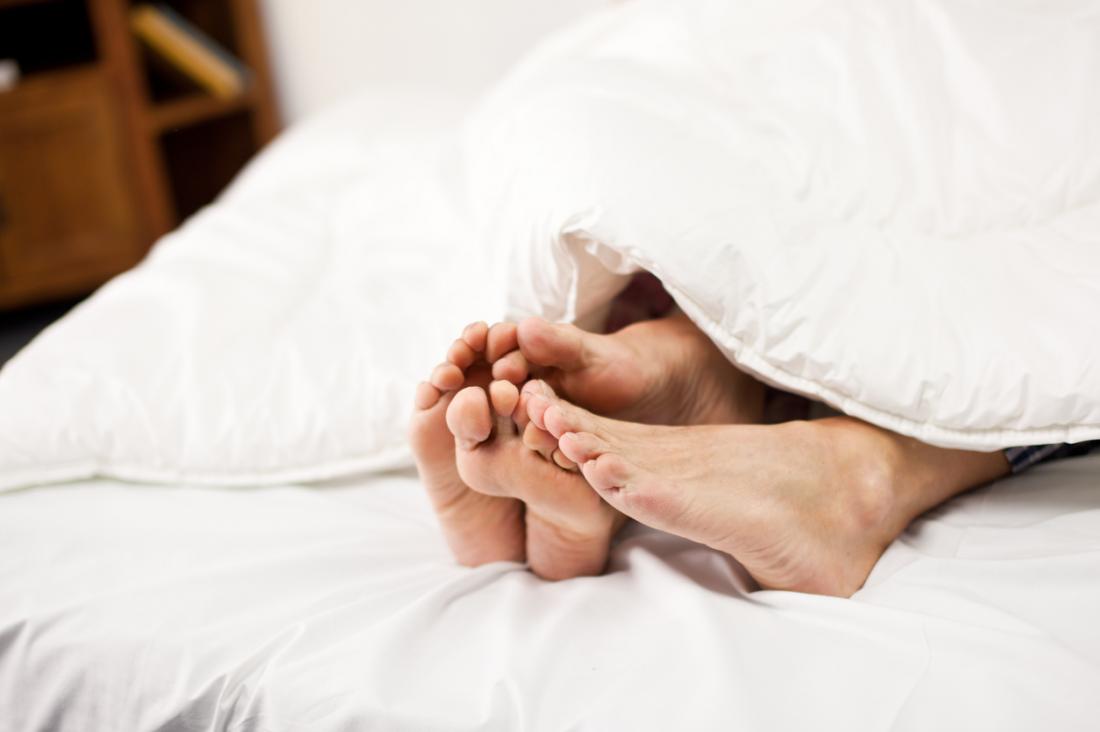 couples feet at end of bed