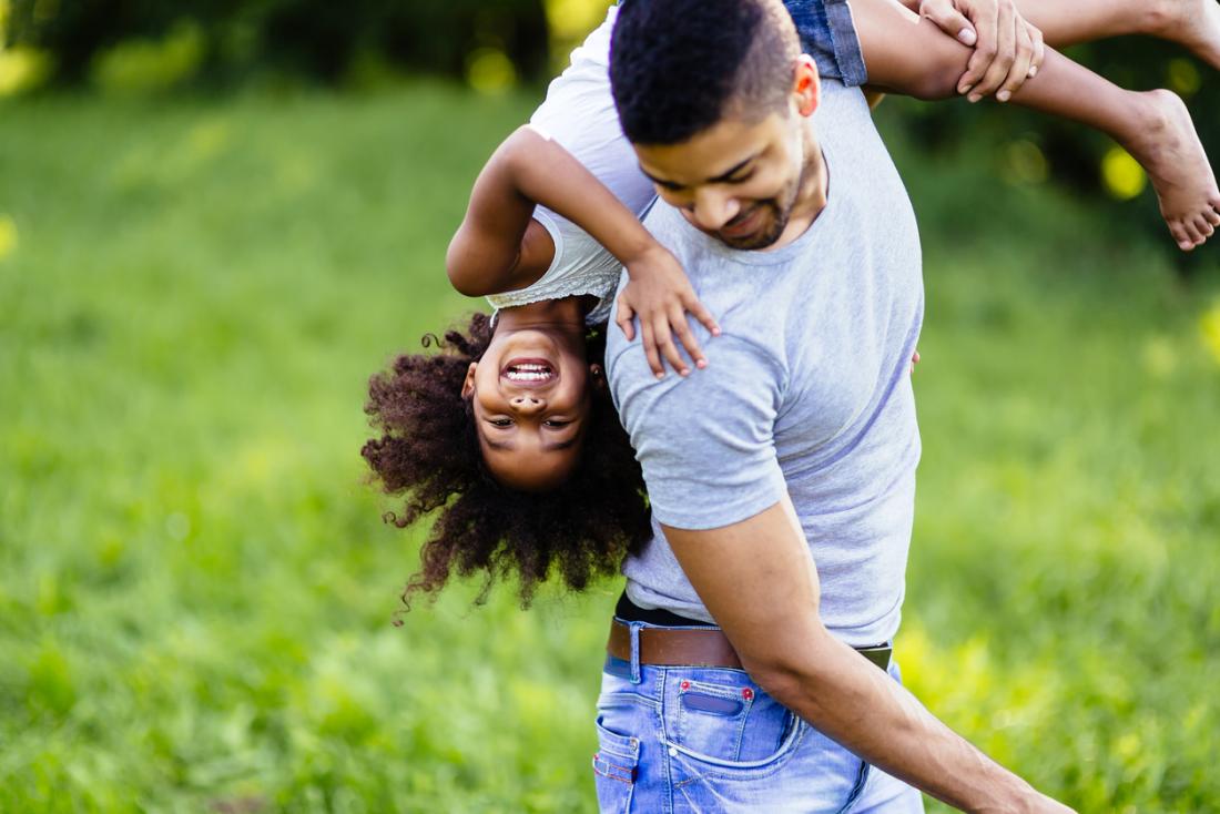 happy father and daughter playing outside