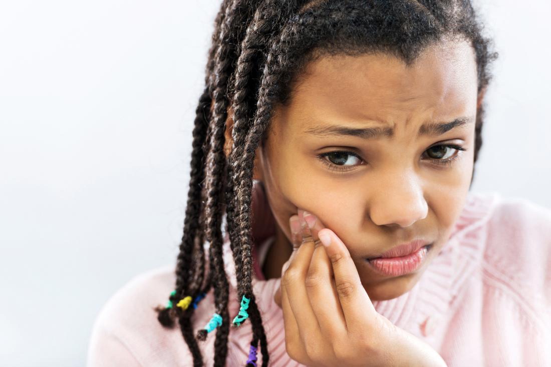 young girl with a toothache