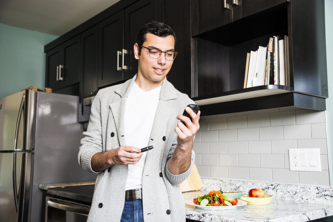 young man checking his blood sugar
