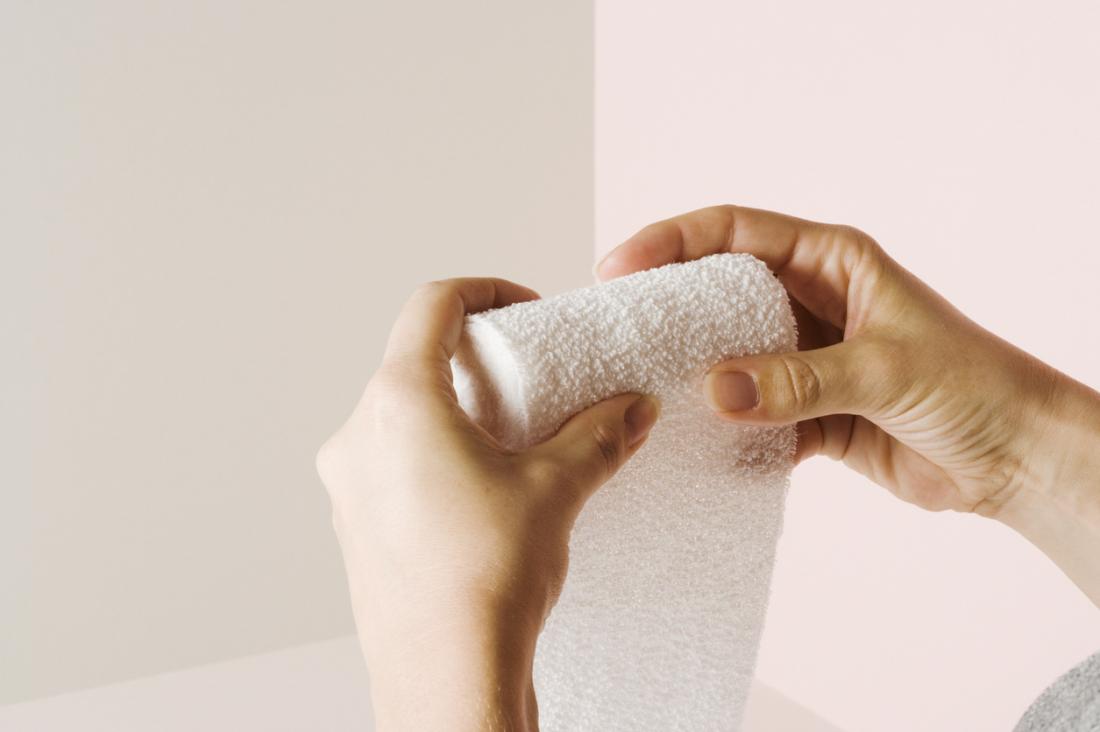woman rolling gauze