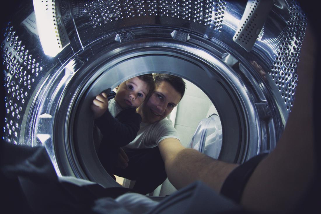 father and child doing laundry