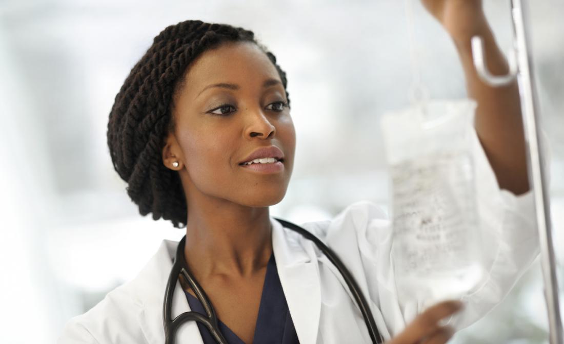 young doctor hooking up an iv line
