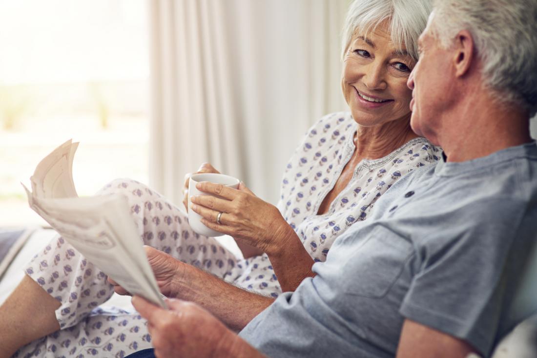 woman drinking tea in bed with her partner