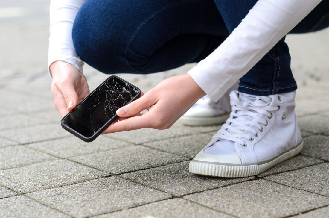lady picks up broken smart phone
