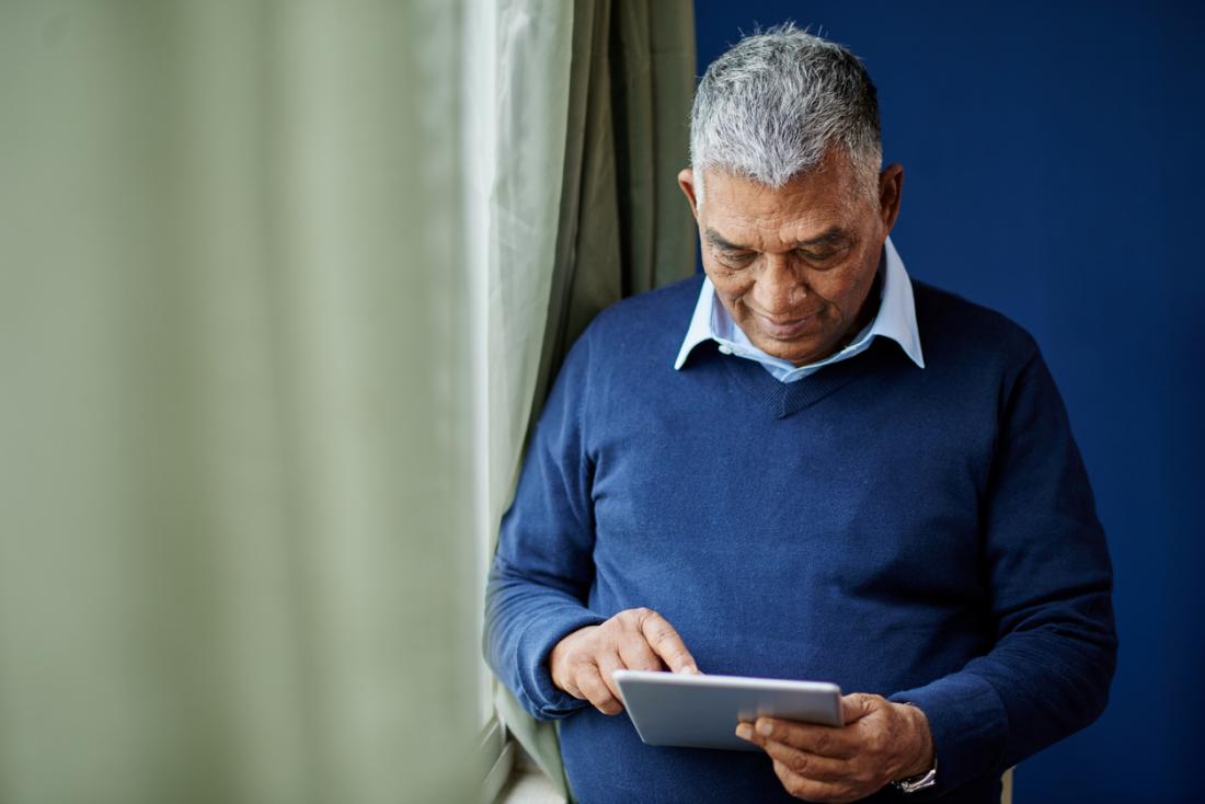 senior playing a game on an ipad