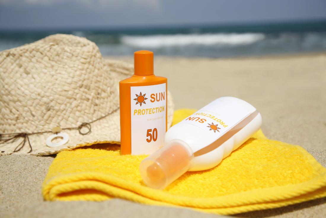 Sunscreen Bottles On A Beach 