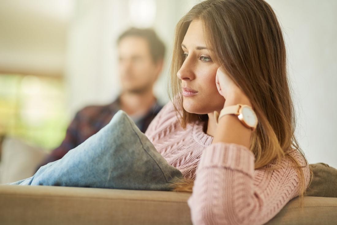 Sad woman with man in the background