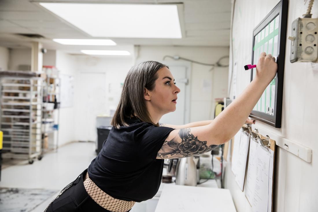 Woman drawing on board confidently