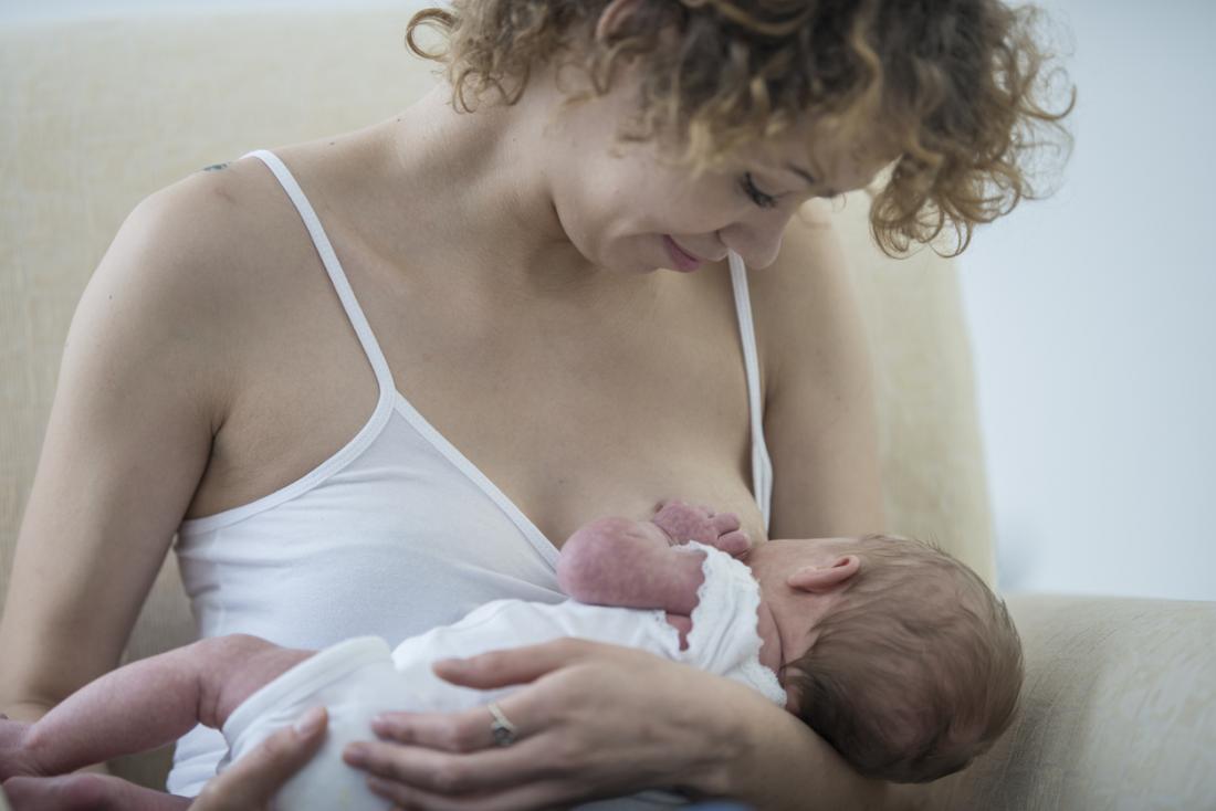a woman breastfeeding her newborn baby