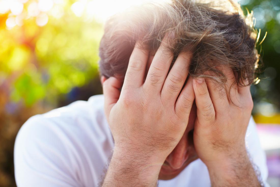 sad man holding his head