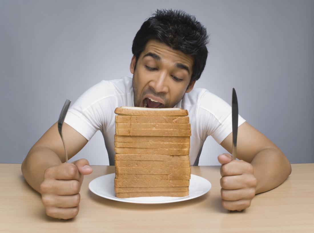 Man eating loads of slices of bread