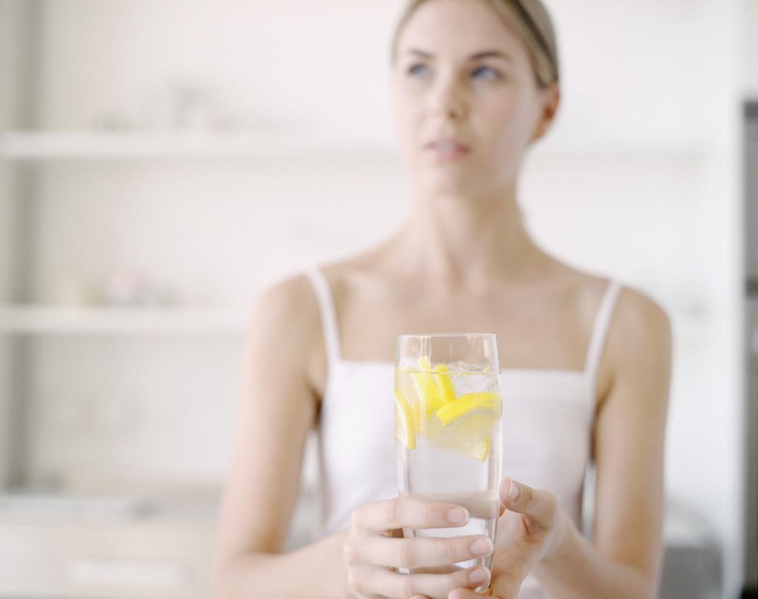 Woman drinking lemon water