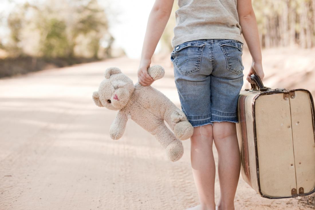 girl with suitcase and teddy